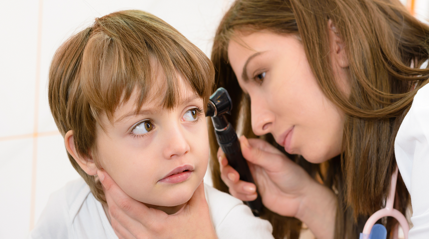 ENT doctor examining boys ear