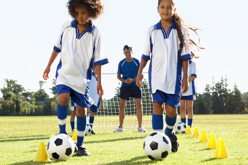 Group of girls practicing on soccer field