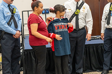 Jestina, mom, and Hollywood Fire Rescue team