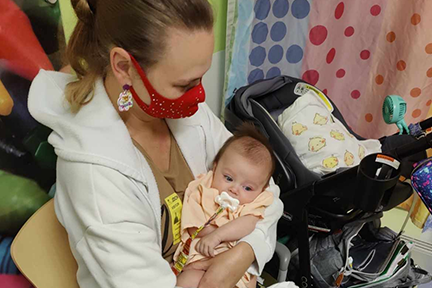 Sarah, Ellia's mom, holding her as a baby