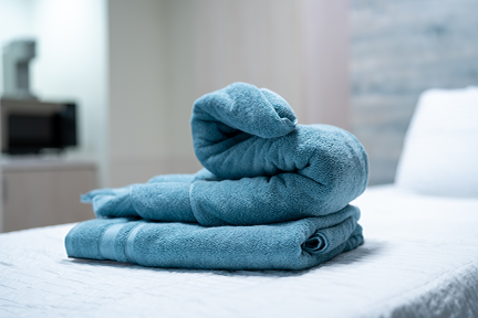 Towels folded nicely on bed in maternity room