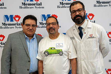 Heart transplant recipient and Drs. Jose Garcia and Iani Patsias