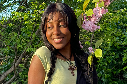 Jenelle standing next to flowering trees